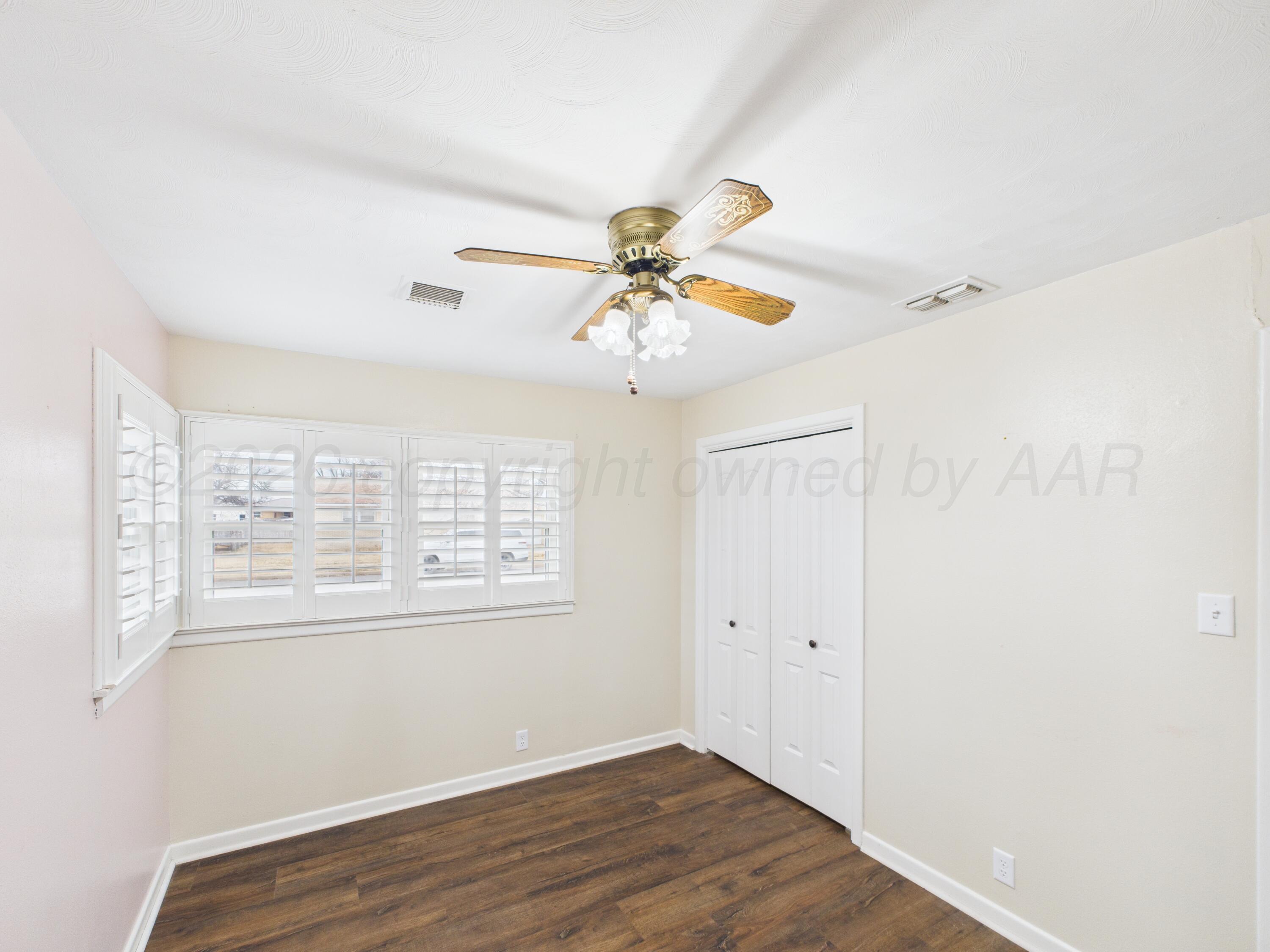 528 North Red Deer Street Pampa, TX 79065 - Photo 31 of 41 a view of an empty room with wooden floor and a window