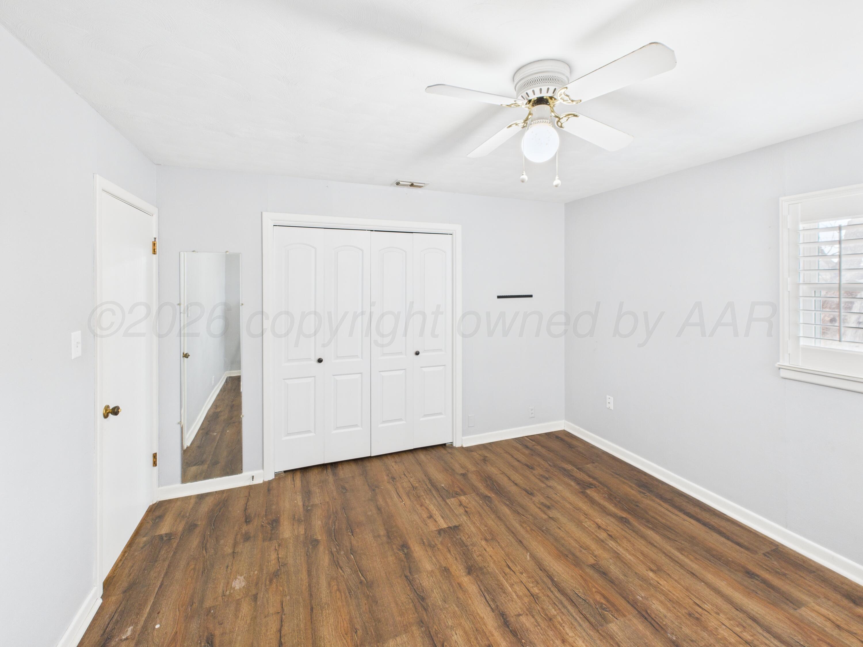 528 North Red Deer Street Pampa, TX 79065 - Photo 33 of 41 wooden floor in an empty room with a window