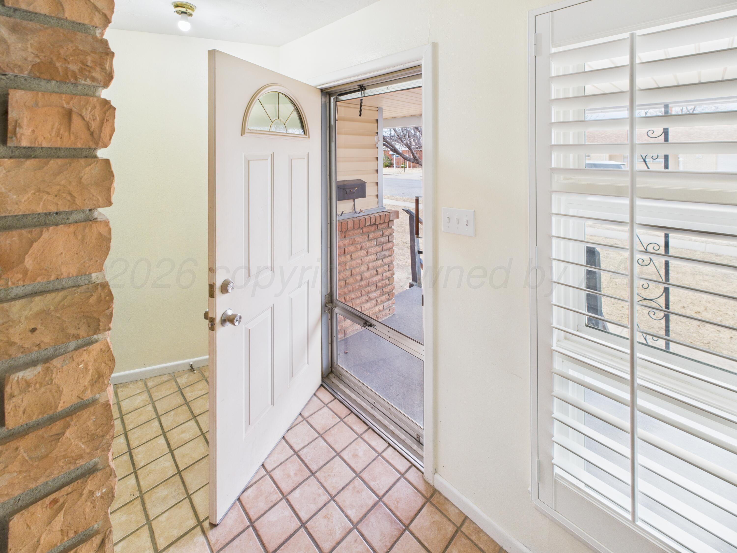 528 North Red Deer Street Pampa, TX 79065 - Photo 4 of 41 a view of a hallway with wooden floor and entryway