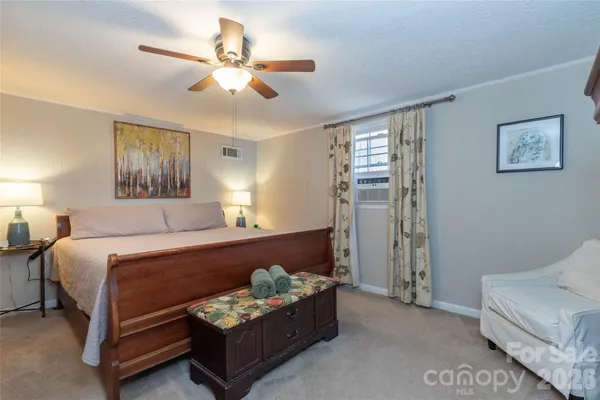 a bedroom with bed and window