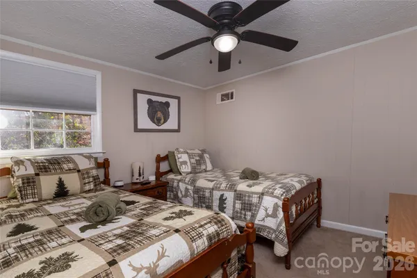 a bedroom with two beds and windows