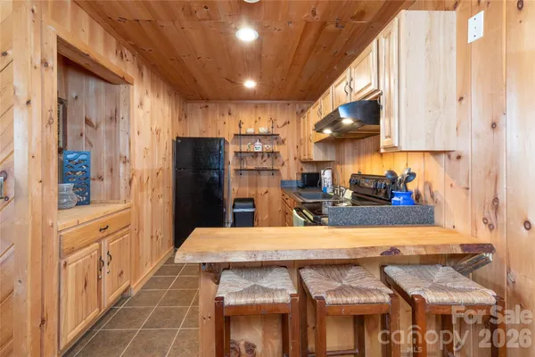 a kitchen with stainless steel appliances kitchen island granite countertop a refrigerator and microwave