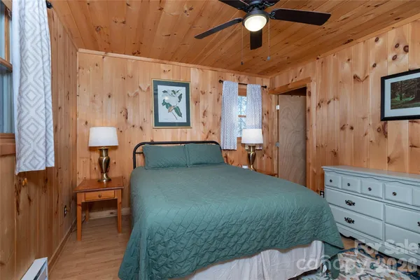 a bed room with a bed and a ceiling fan
