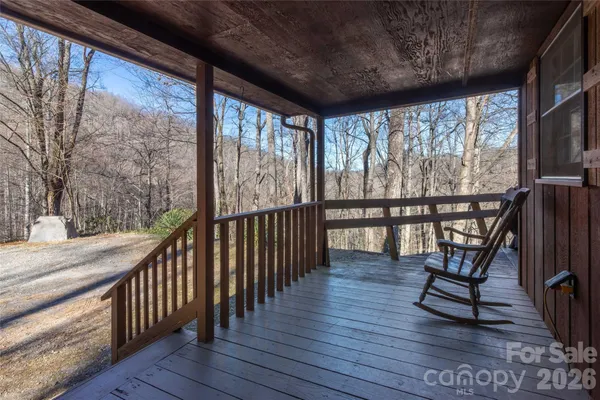 a view of a porch with wooden floor and outdoor seating