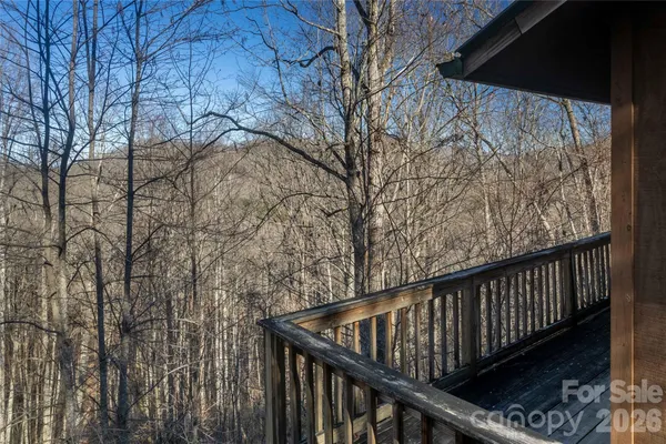 a view of balcony with wooden floor and fence
