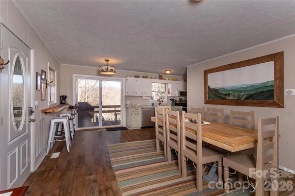a living room with furniture a flat screen tv and a floor to ceiling window