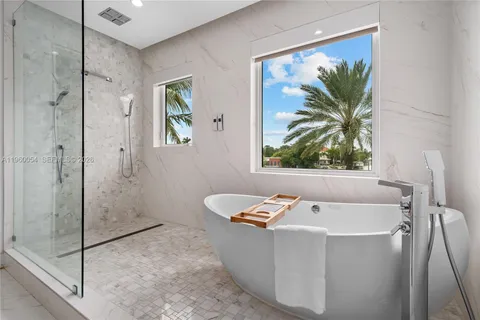 a bath tub sitting next to a window