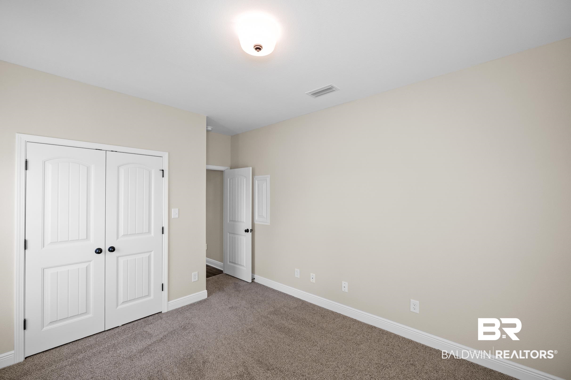 12833 Ward Road West Stapleton, AL 36578 - Photo 20 of 27 Unfurnished bedroom featuring carpet flooring and a closet