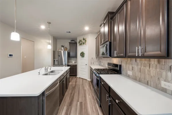 a kitchen with a sink stove and cabinets
