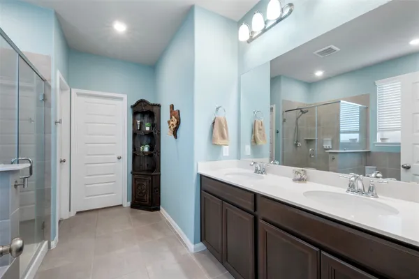 a bathroom with a double vanity sink a vanity and a mirror