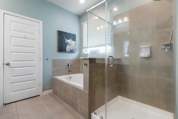 a bathroom with a tub a sink and mirror