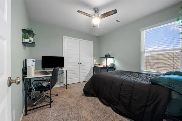 a bedroom with a bed and a flat screen tv