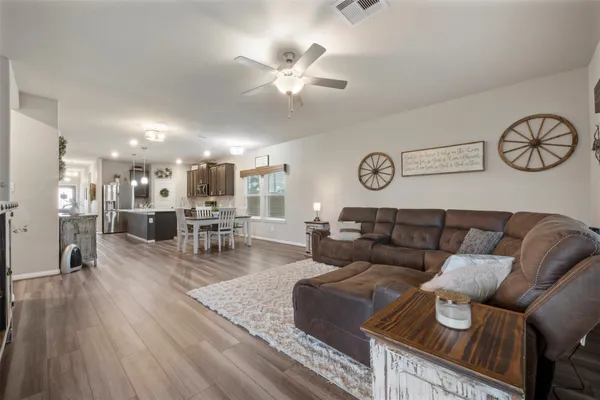 a living room with furniture and wooden floor