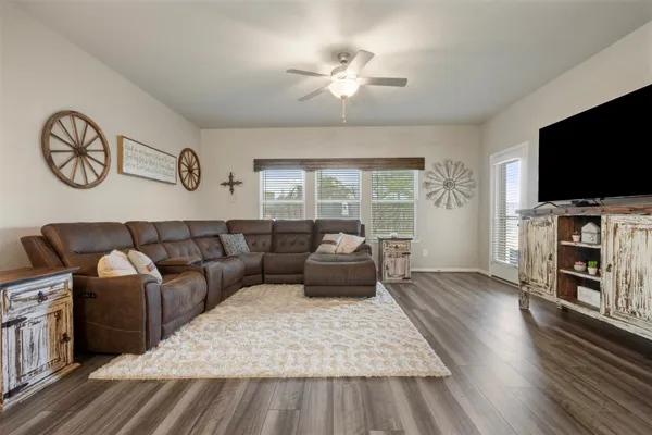 a living room with furniture and a flat screen tv