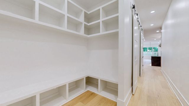 a view of an empty room with a fireplace and a window