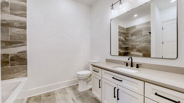 a living room with furniture fireplace and a large window