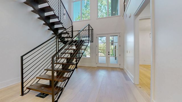 a kitchen with stainless steel appliances kitchen island granite countertop a sink and a refrigerator