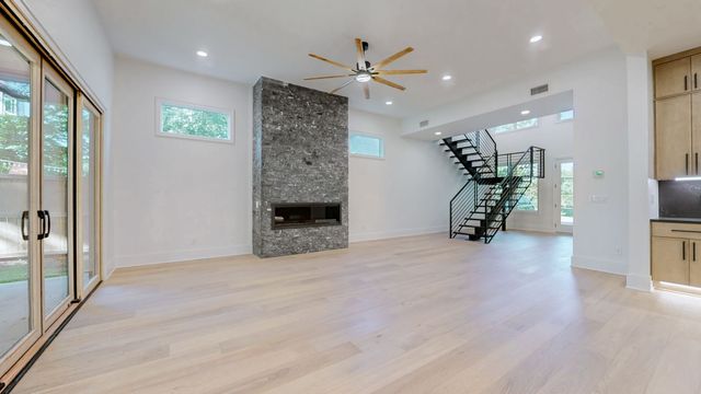 a view of a hallway with wooden floor and staircase
