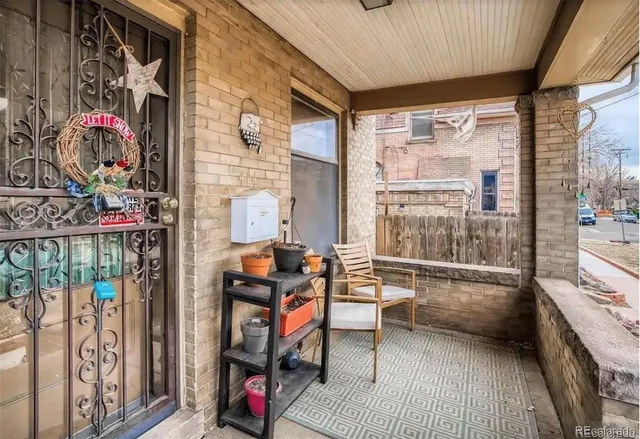 a living room filled with furniture and a floor to ceiling window