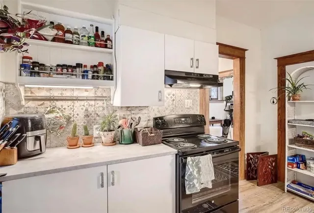 a kitchen with stainless steel appliances a stove and cabinets