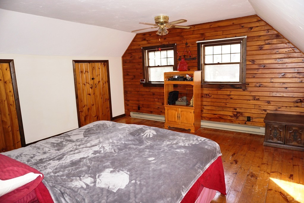 63 Breakneck Road Sturbridge, MA 01566 - Photo 21 of 30 a bedroom with a bed and a dresser