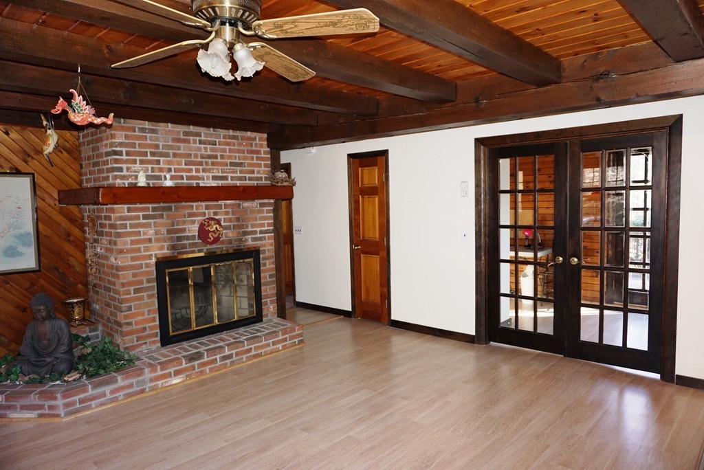63 Breakneck Road Sturbridge, MA 01566 - Photo 6 of 30 a view of an empty room with wooden floor fireplace and a window