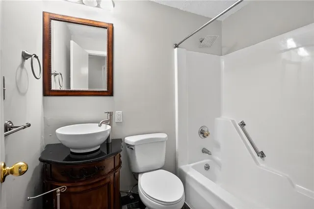 a bathroom with a toilet a sink and bathtub