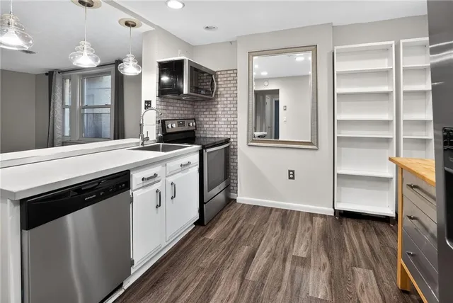 a kitchen with a stove oven and sink