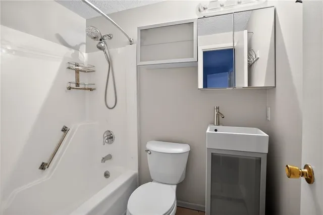 a bathroom with a toilet sink and shower