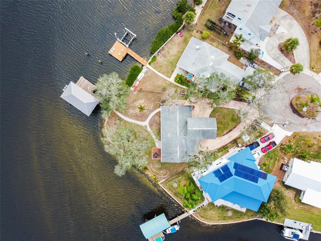an aerial view of a house a yard and a fire pit