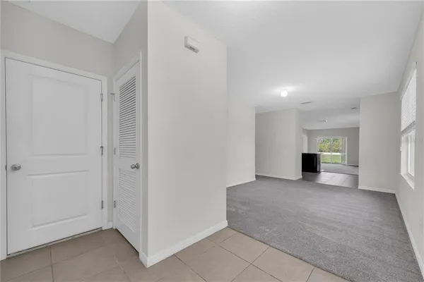 an empty room with windows and entrance