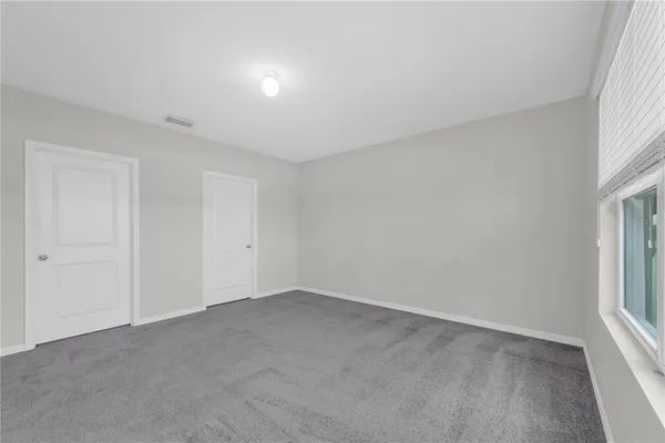 a view of an empty room and a window