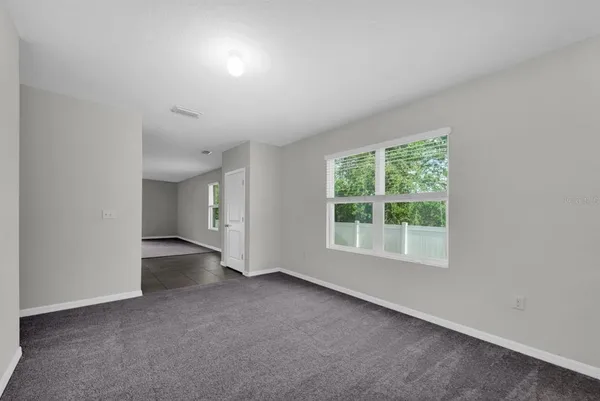 an empty room with a empty space and windows