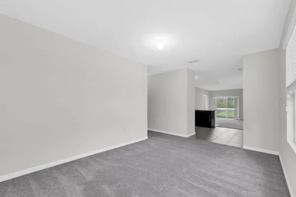 a view of an empty room with a kitchen