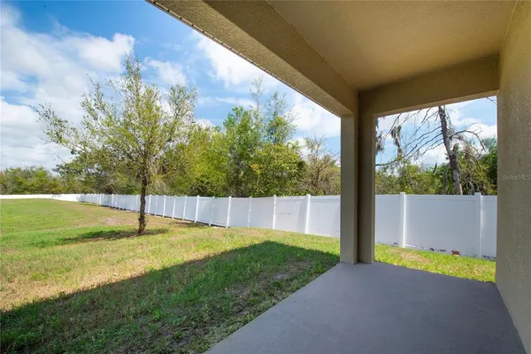 a swimming pool with an outdoor space and seating area