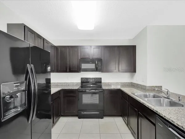 a kitchen with a sink a stove and refrigerator