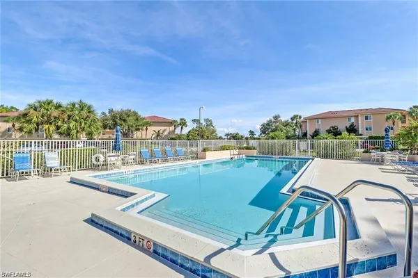 a view of swimming pool with outdoor seating and plants