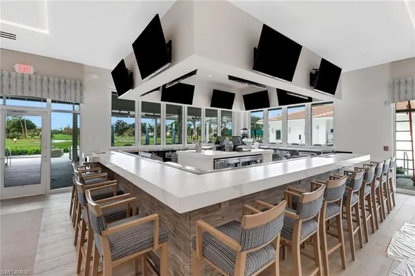 a kitchen with a stove and a flat screen tv