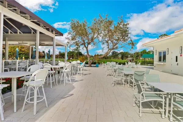 a view of a patio with a table and chairs and potted plants
