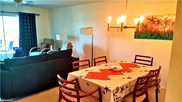a dining room with furniture and wooden floor
