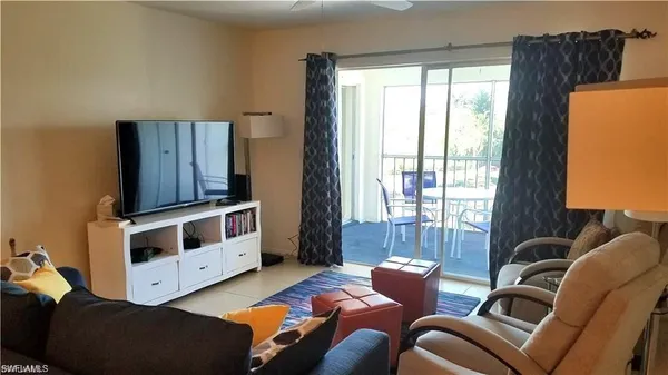 a living room with furniture and two windows