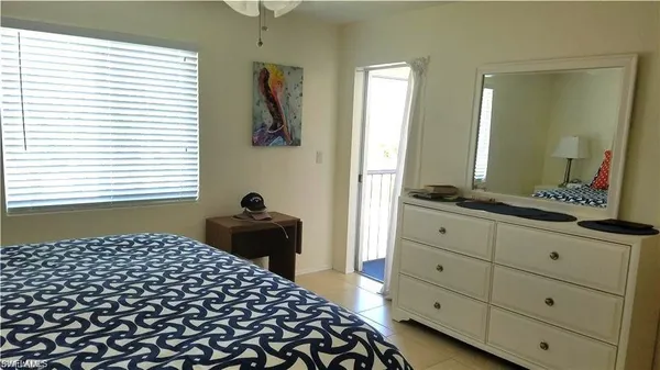 a bedroom with a bed and a closet with mirror
