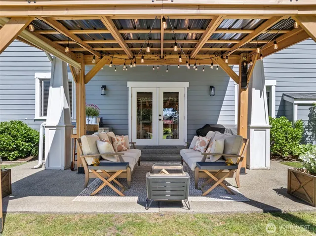 a view of a patio with table and chairs and potted plants