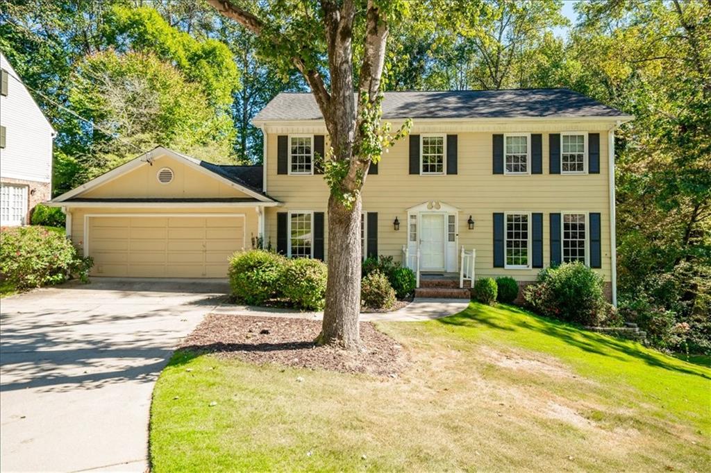 5177 Riverhill Road Northeast Marietta, GA 30068 - Photo 1 of 1 a front view of a house with yard and green space