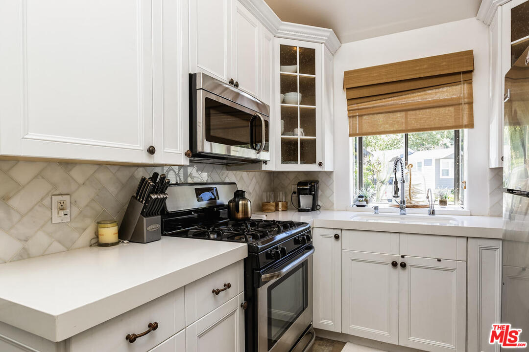 45 Paradise Cove Road Malibu, CA 90265 - Photo 8 of 15 a kitchen with cabinets appliances a sink and a window