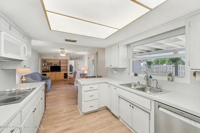 a kitchen with sink stove and cabinets