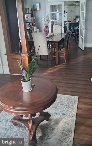 a dining room with furniture and wooden floor