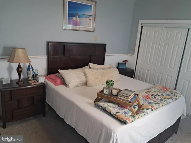 a bedroom with a bed and a dresser