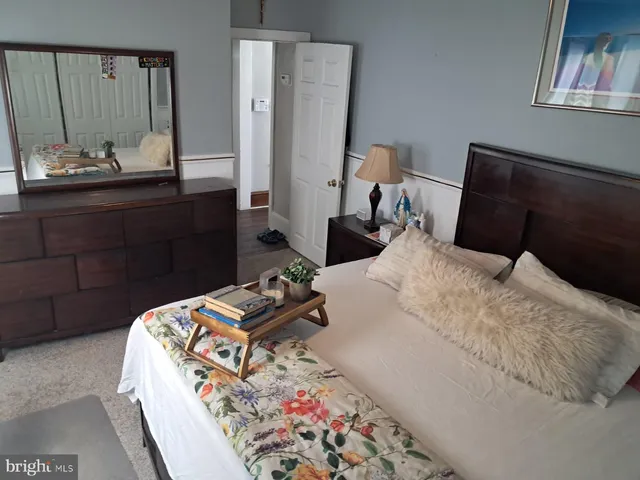 a bedroom with bed and wooden floor