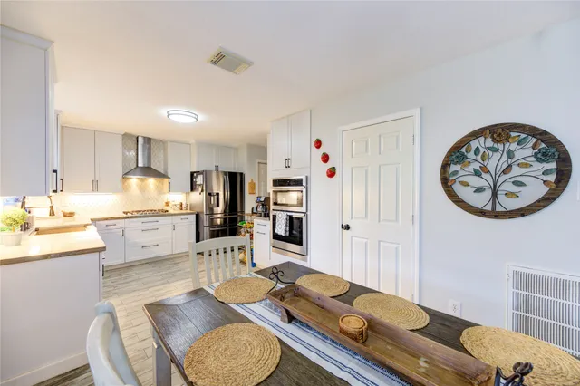 a kitchen with refrigerator cabinets and wooden floor